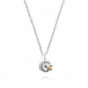 Close-up of bee and flower detail on two-tone pendant