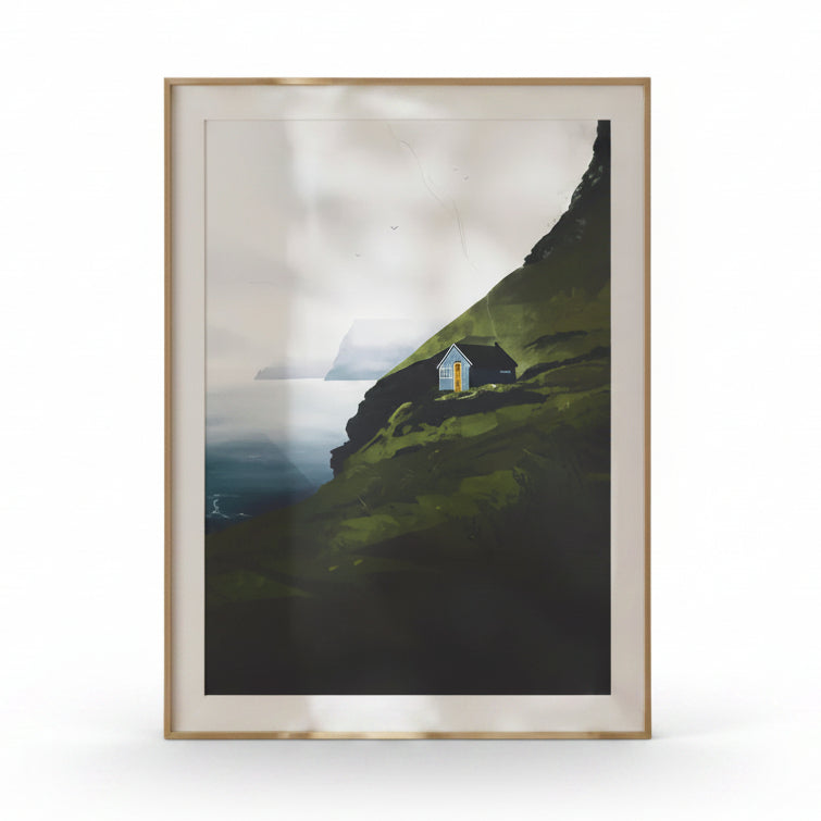 Framed artwork of a house on a hillside with a mountainous background.