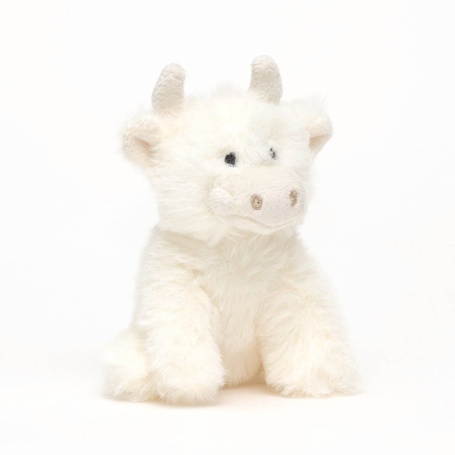 Cream highland cow mini plush sitting front view on white