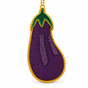 Aubergine embroidered decoration close up, showing the purple fabric and gold metal thread