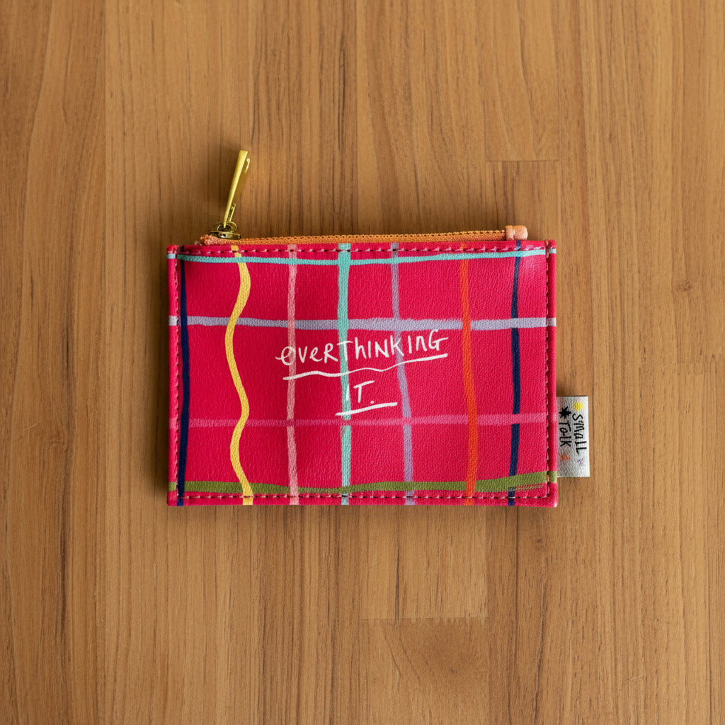 Overthinking It zip purse front view styled on yellow grid background