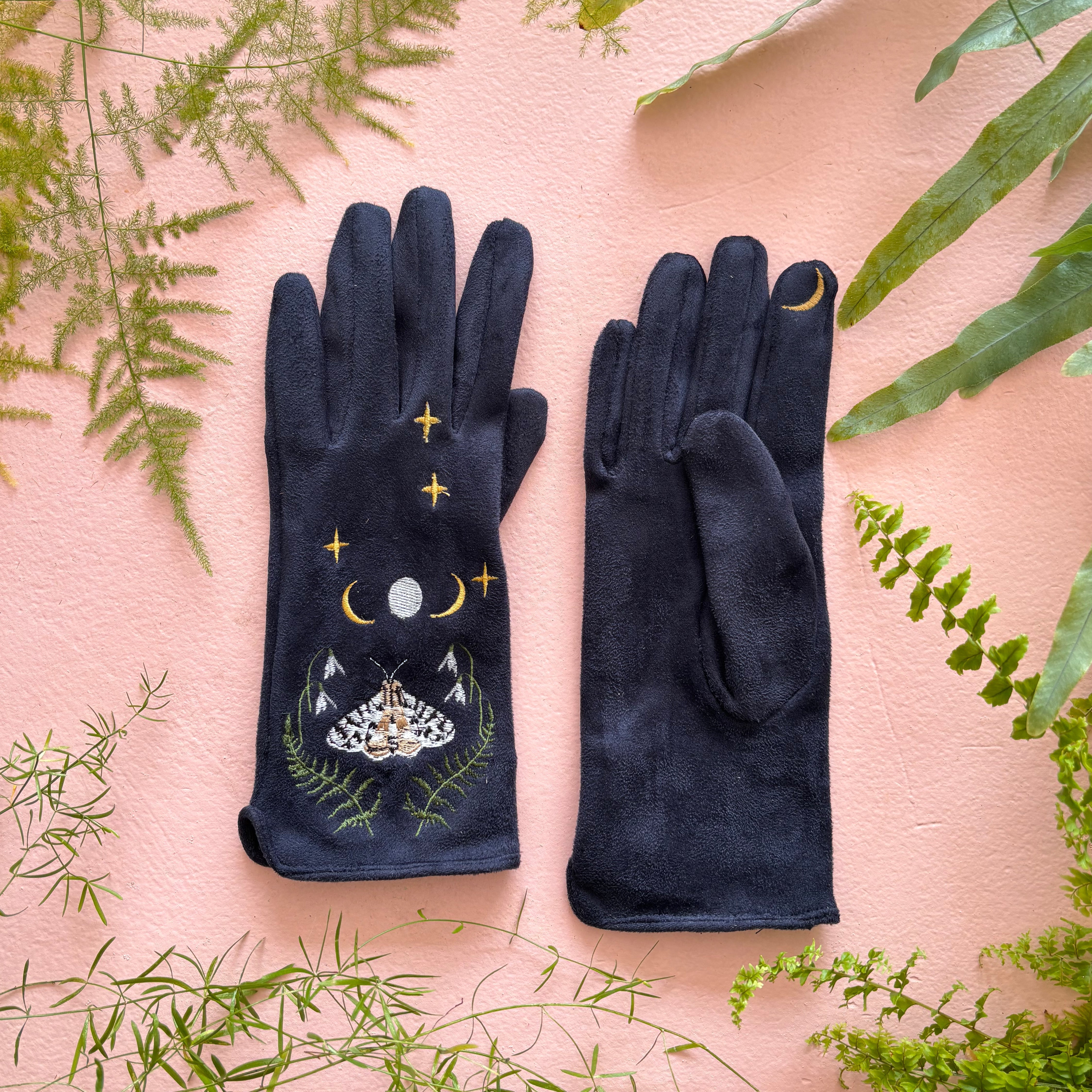 Both moth gloves laid flat showing embroidered fronts on pink background