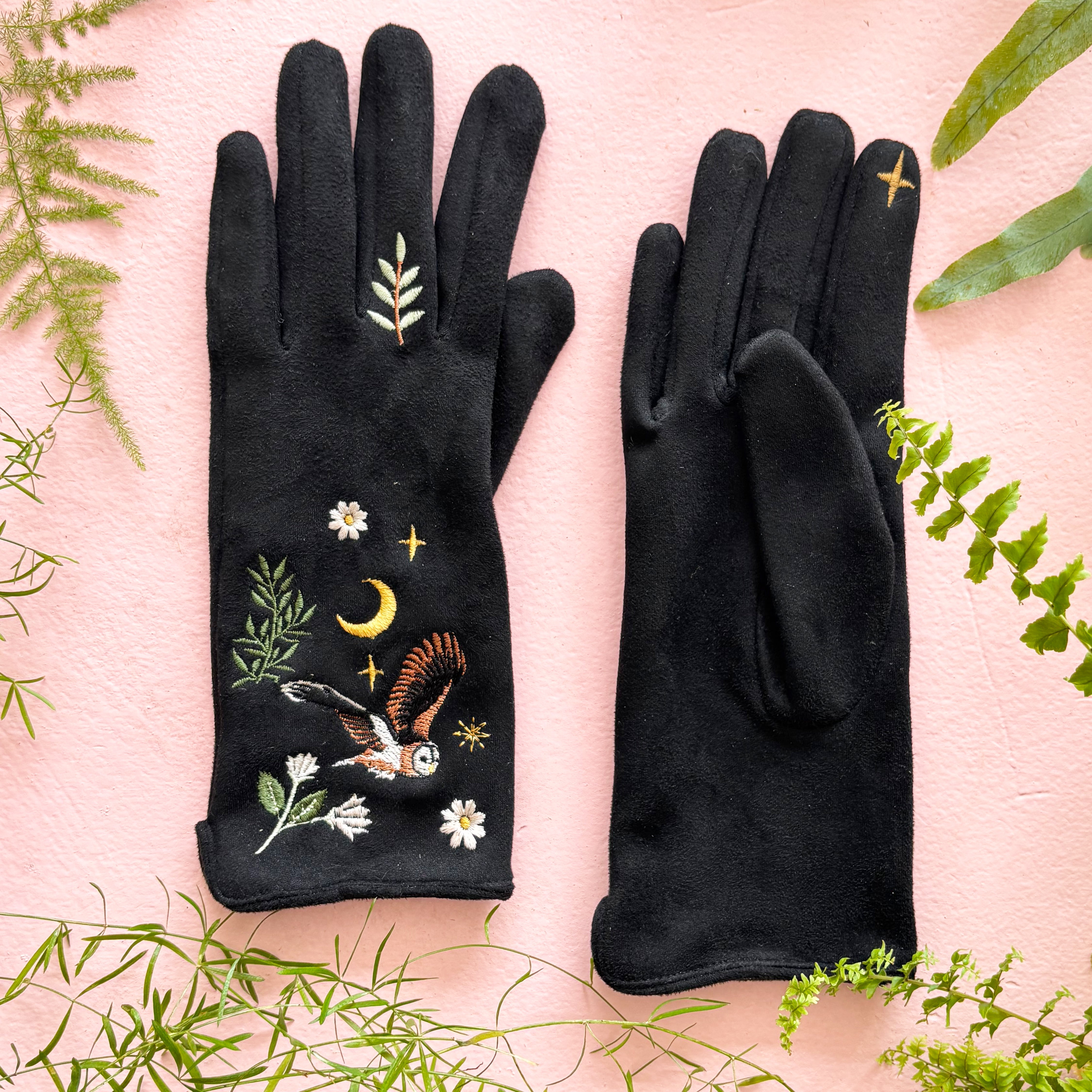 Owl gloves flat lay showing front embroidery and plain back on pink background