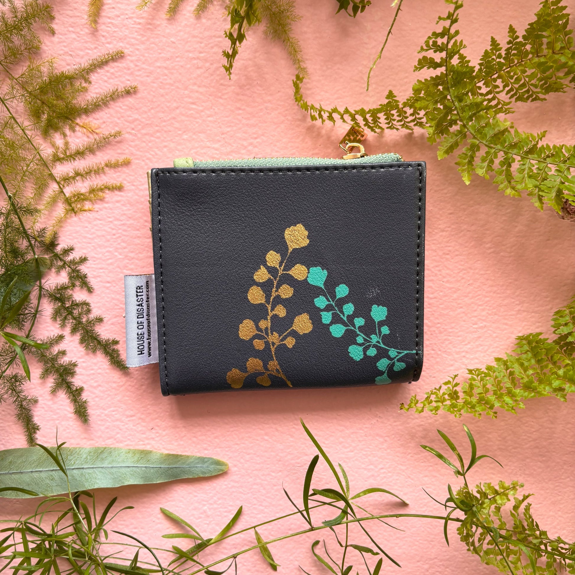 Rabbit purse back view with gold and teal leaf print on pink background