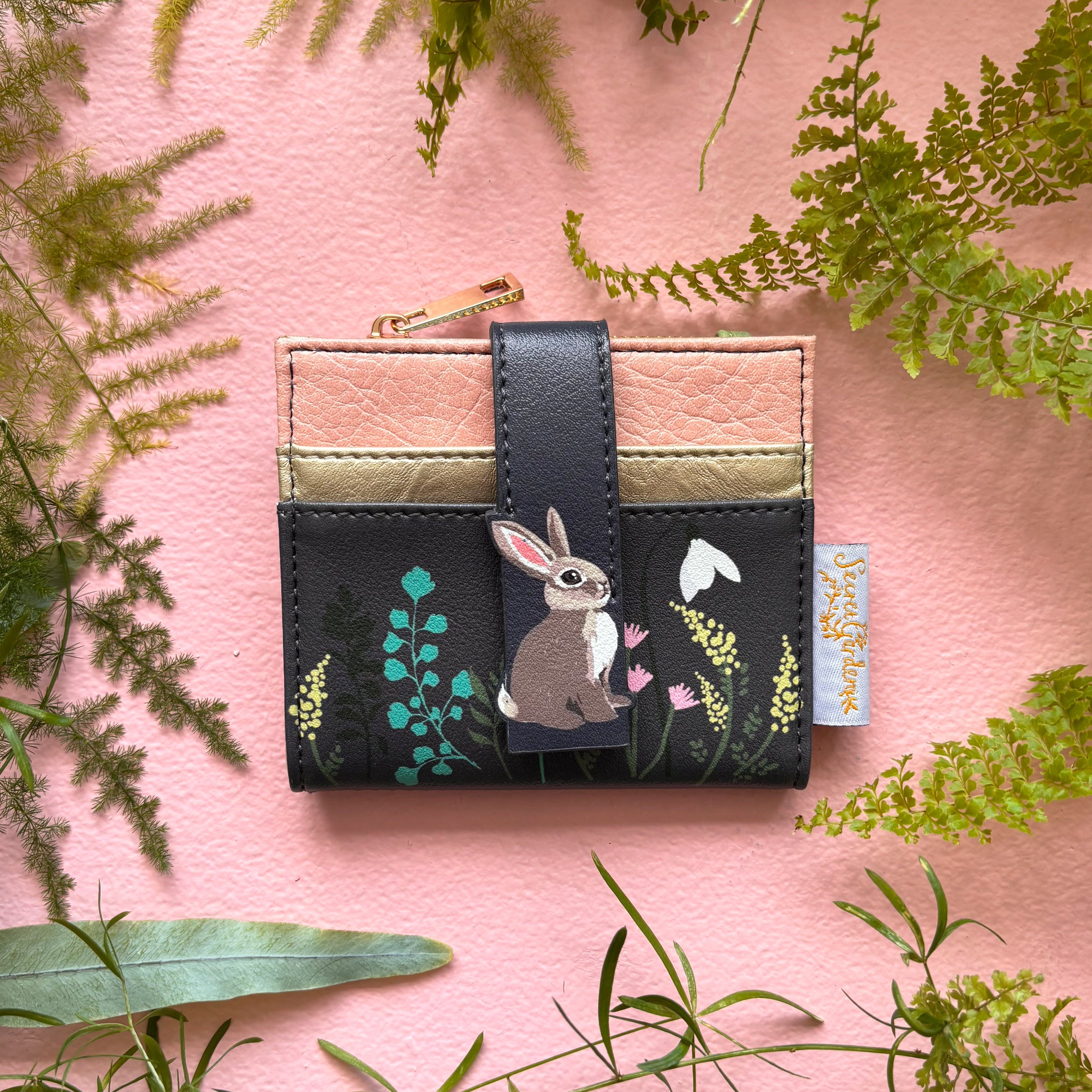 Secret Garden rabbit foldover purse front view on pink background