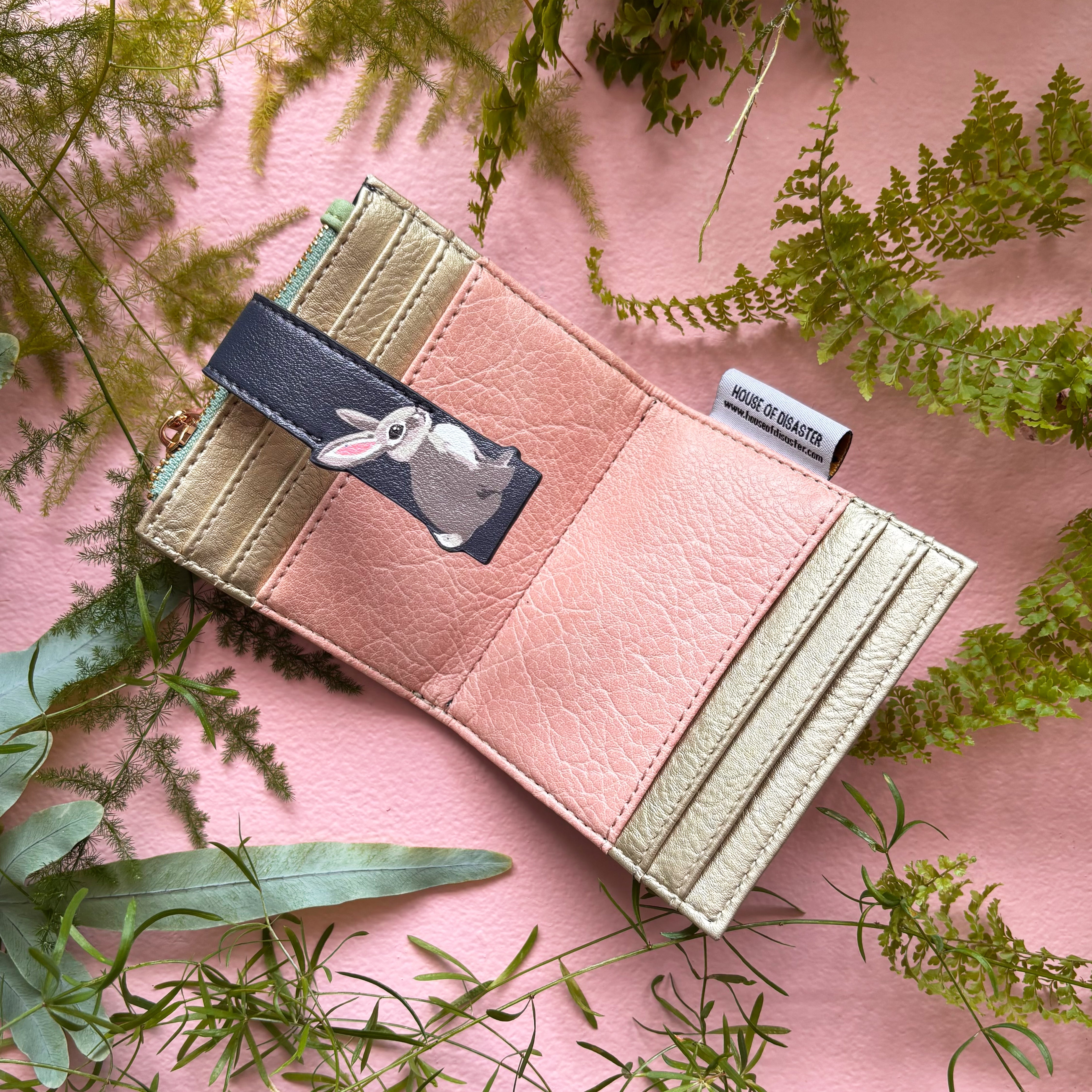 Rabbit purse open showing pink and gold card slot interior