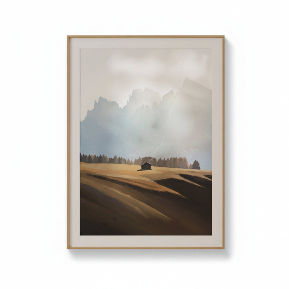 A framed landscape art print featuring a misty mountain range, a lone cabin, and rolling hills in muted earth tones, displayed against a clean white background.