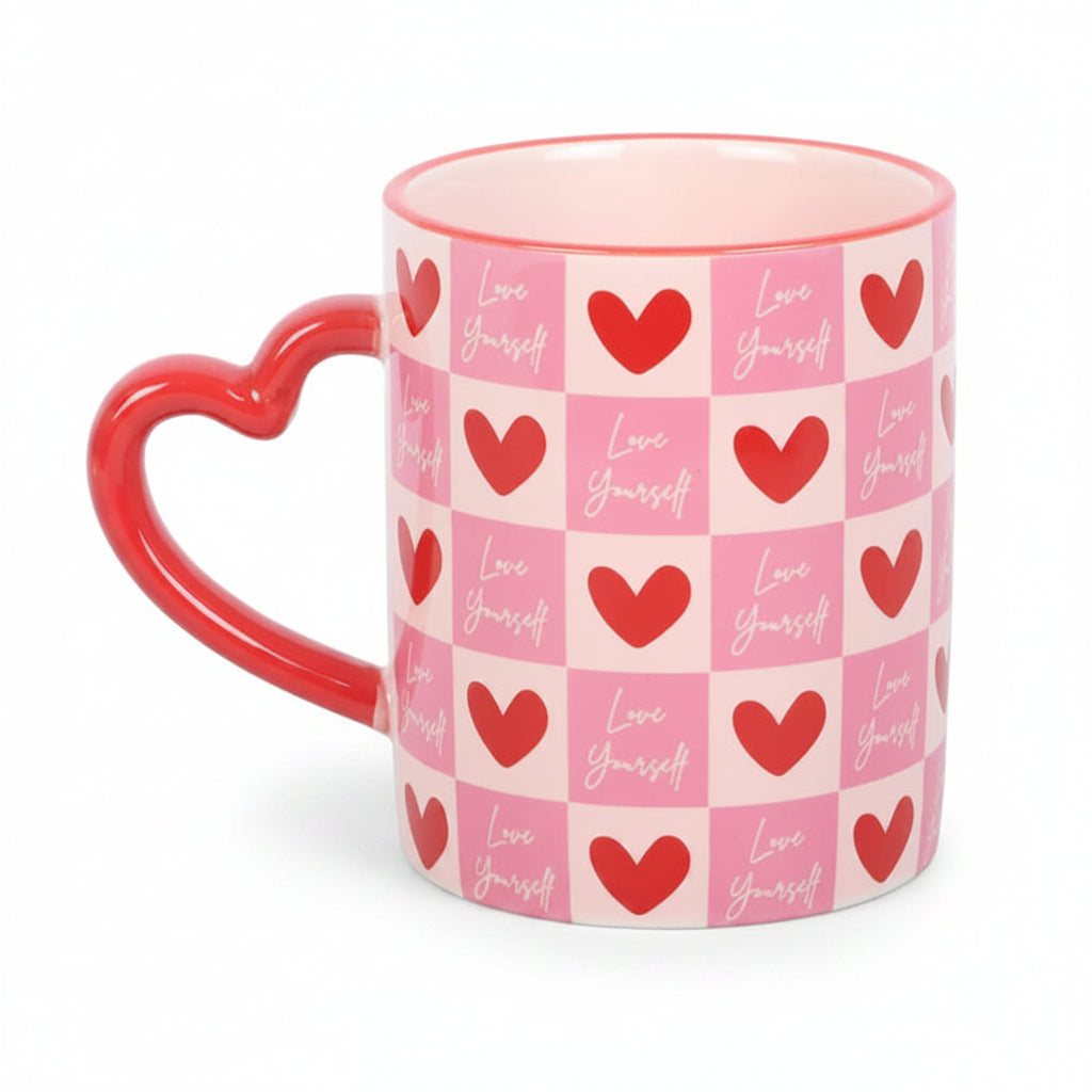 Pink checkerboard Love Yourself mug with red heart handle on white background