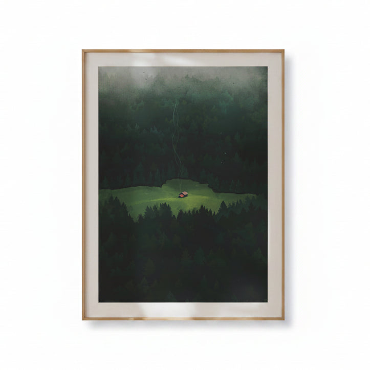 Framed artwork of a landscape with a house in the middle of a forest on a beige wall.