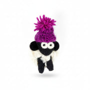Hand-knitted wool sheep fridge magnet wearing a purple bobble hat