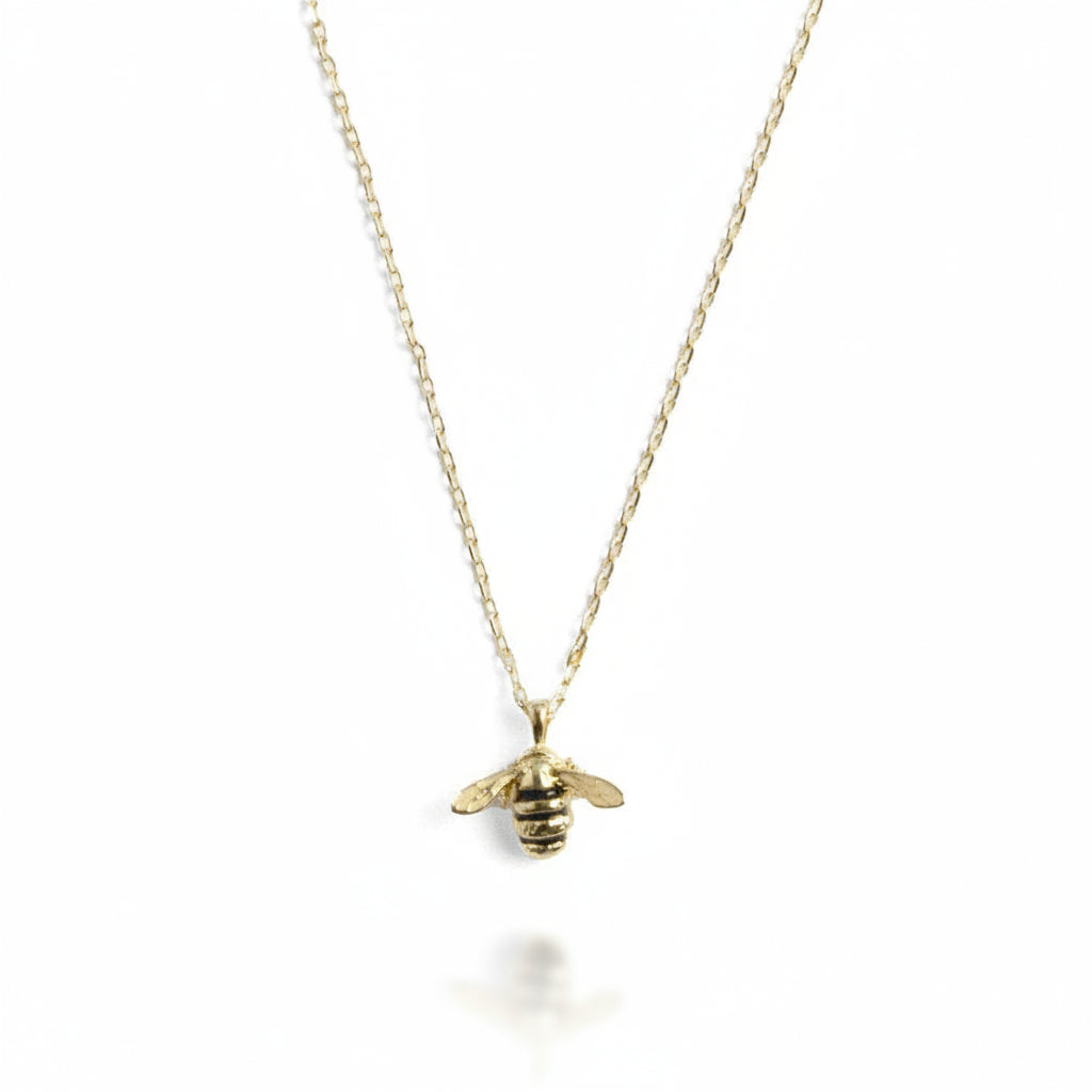 Close-up of bee pendant showing enamel detail