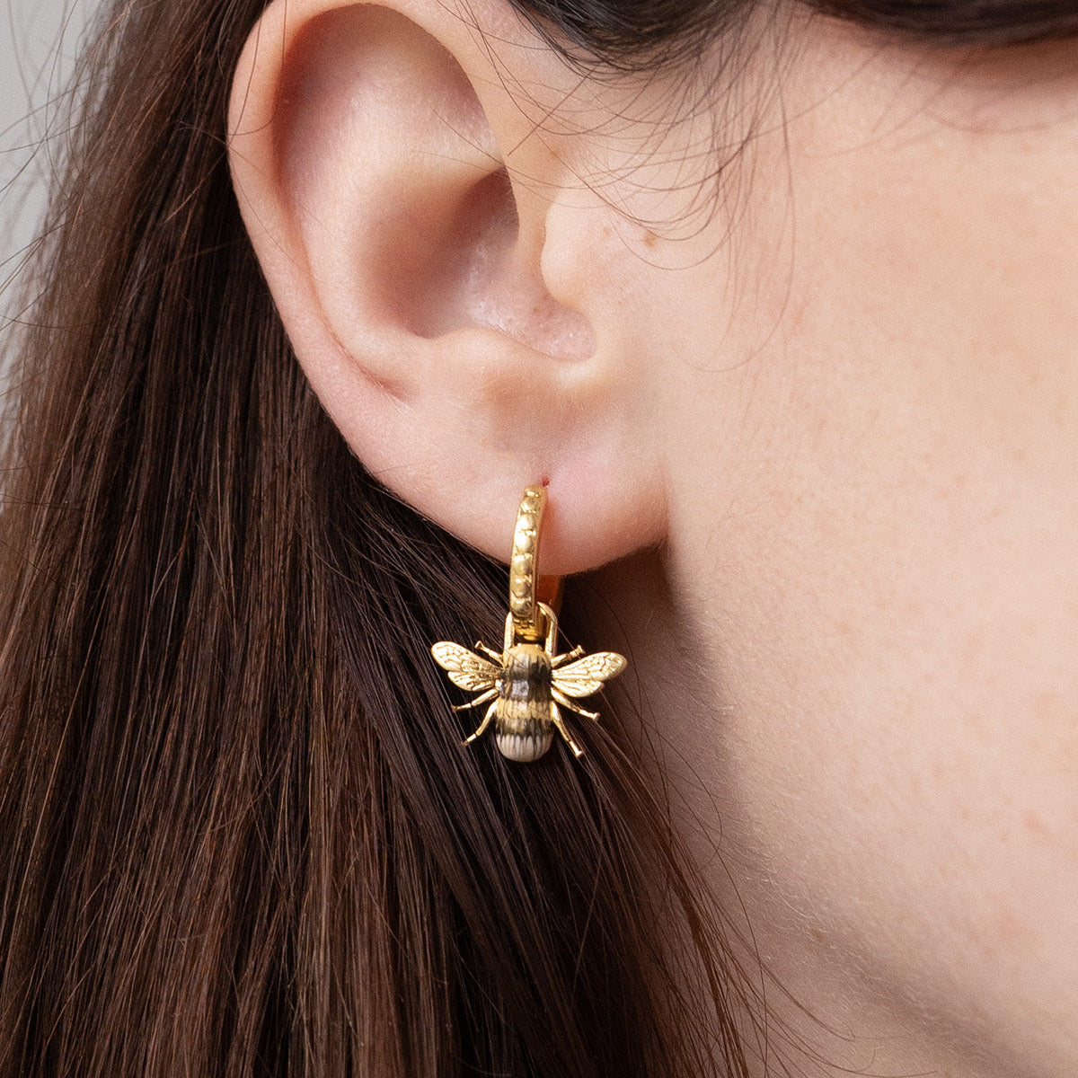 Model wearing the Bee Huggie Earrings