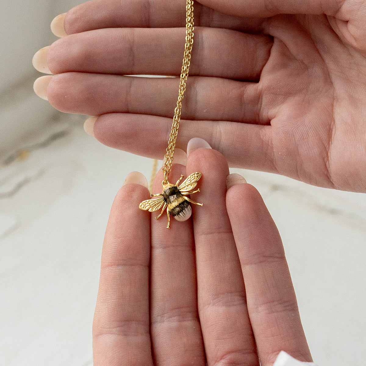 Close-up detail of the Bee Necklace on white