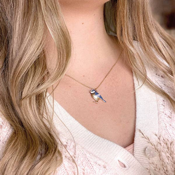 Fable England blue tit necklace worn by model with cream cardigan