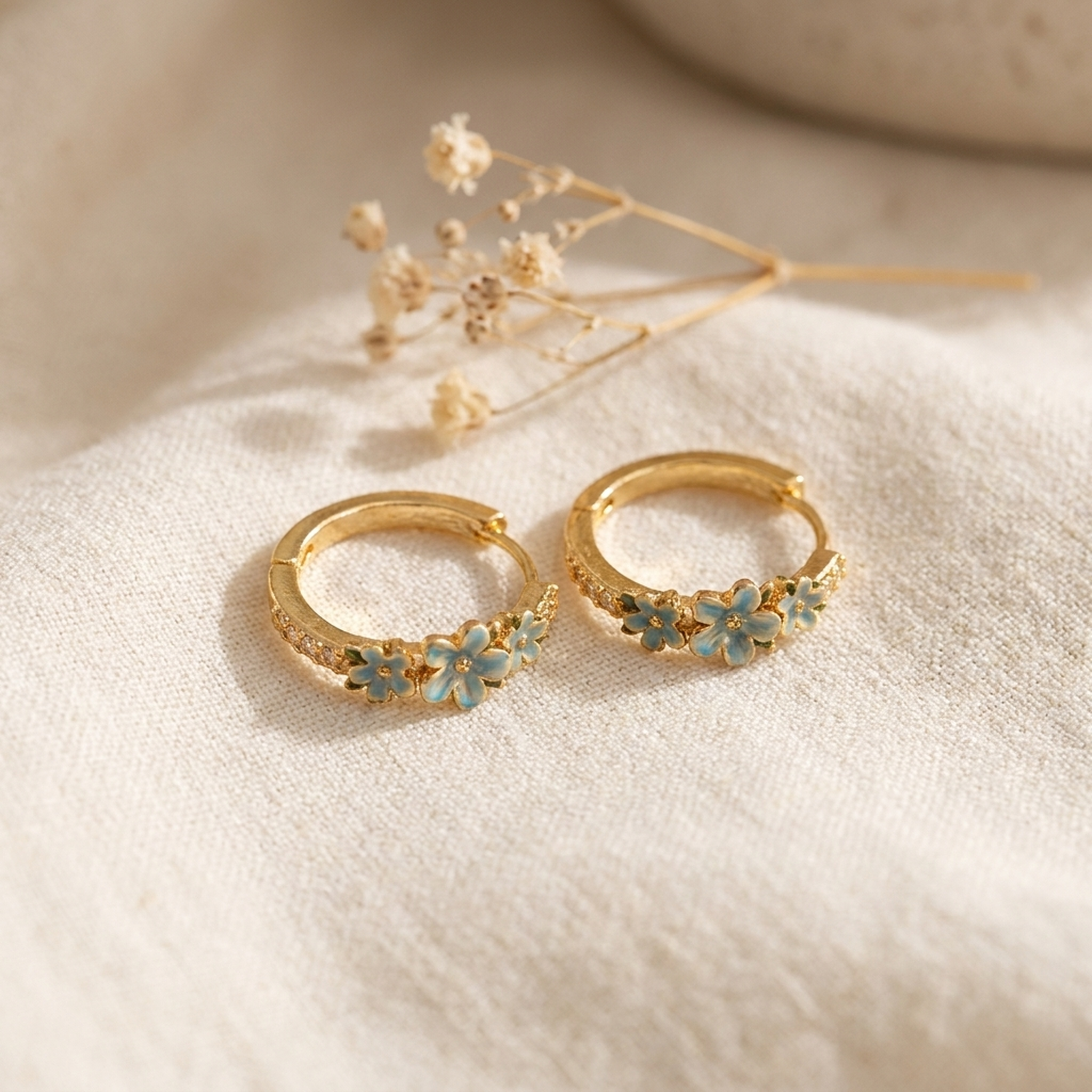 Floral Wreath Hoop Earrings styled on cream linen with dried flowers
