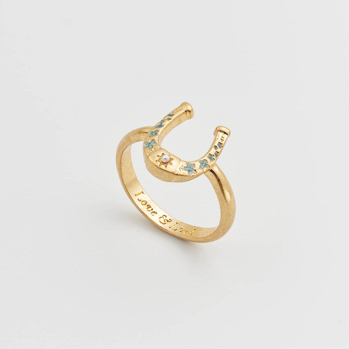 Horseshoe ring angled view showing both enamel detail and engraving