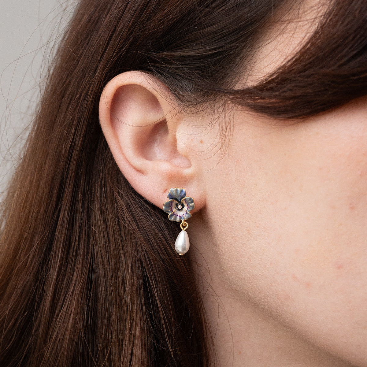 Model wearing the Pansy Pearl Drop Earrings, close view