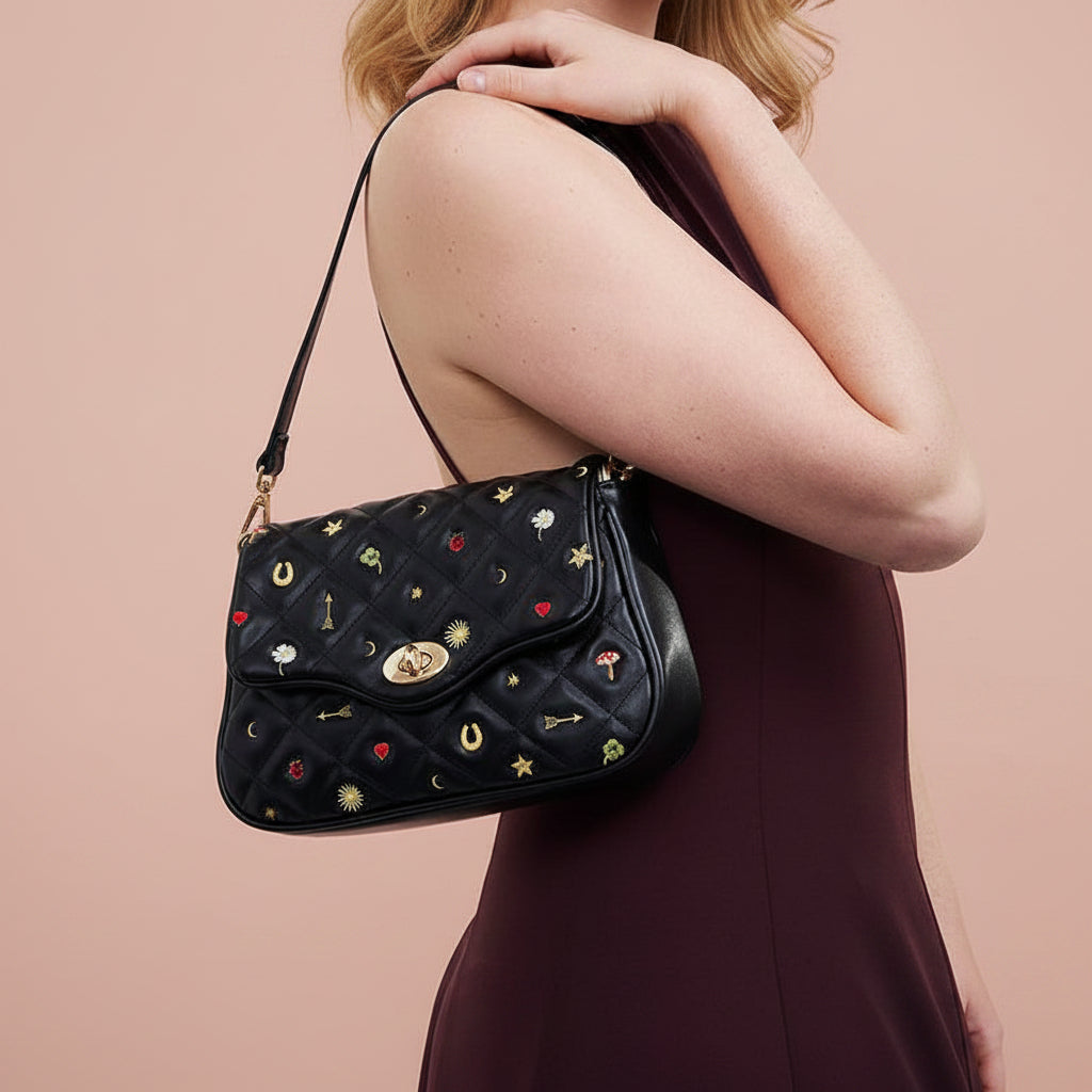 Black Quilted Motif Embroidered Crossbody angled view displaying turn-lock closure and quilted texture