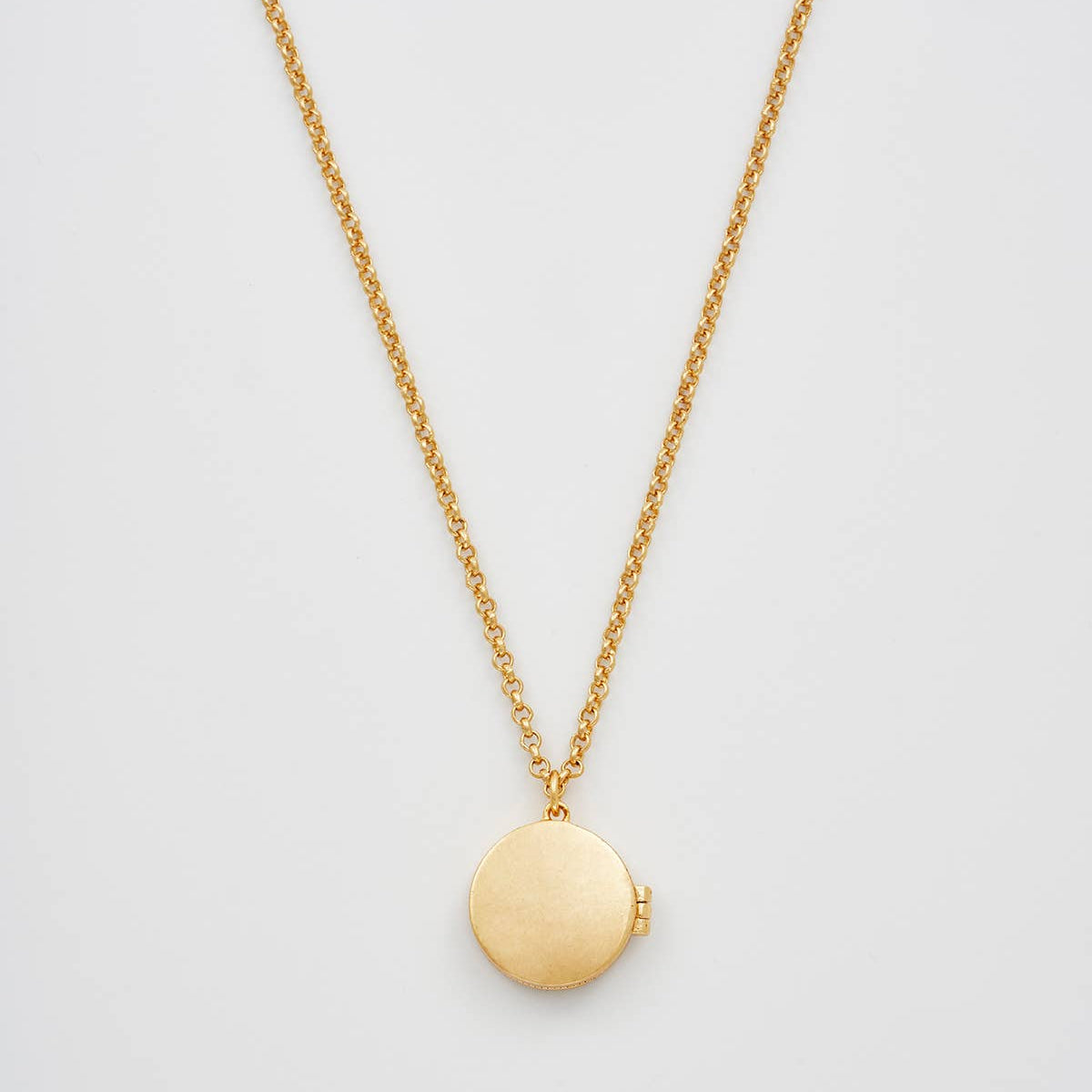 Sun locket necklace back view showing plain gold reverse