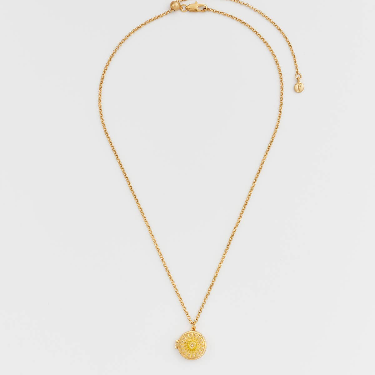 Sun locket necklace laid flat showing clasp and slider bead extender