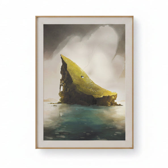A framed art print depicting a dramatic coastal rock formation rising from calm water under a cloudy sky, shown against a plain white background.
