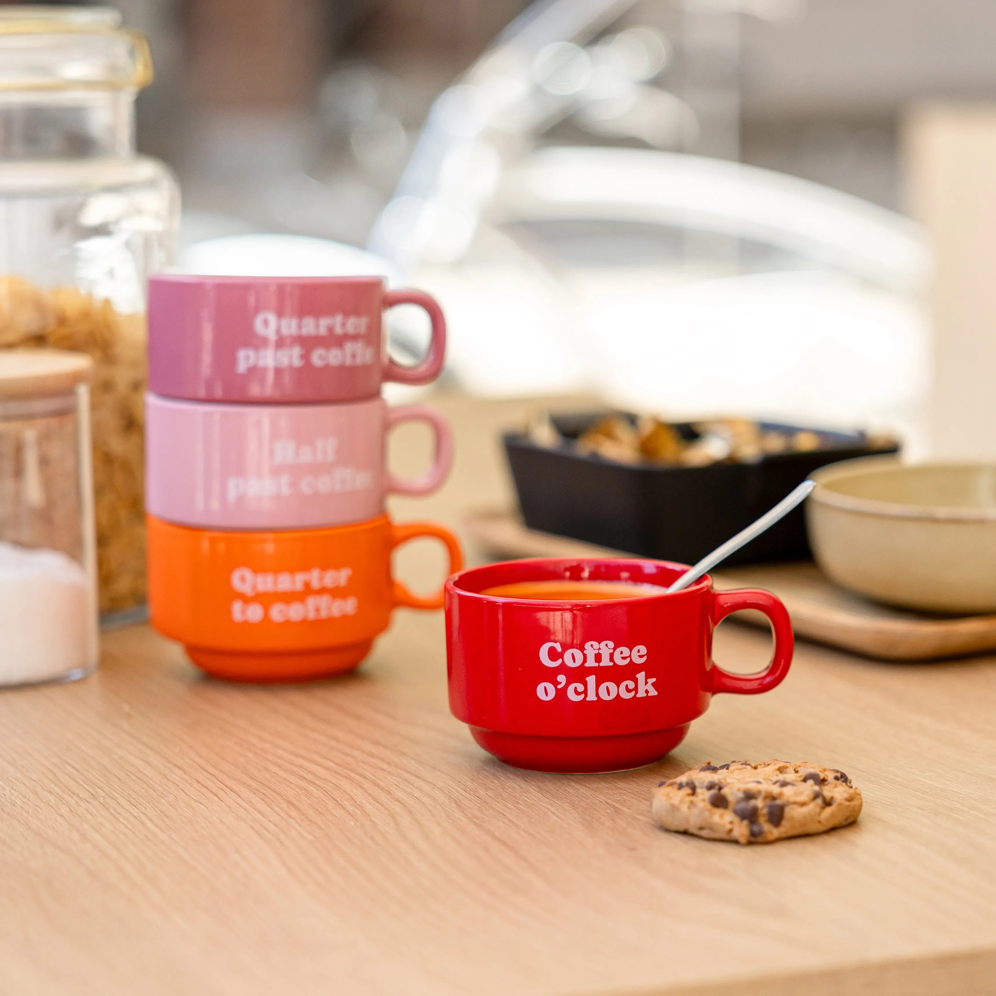 Coffee Clock mugs on a wooden table with biscuits and a bowl of cereal
