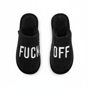 Black fluffy slippers with bold white lettering, side by side