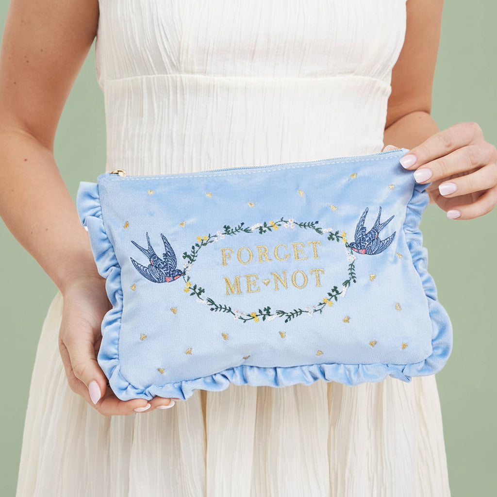 Forget Me Not blue velvet pouch held in hands