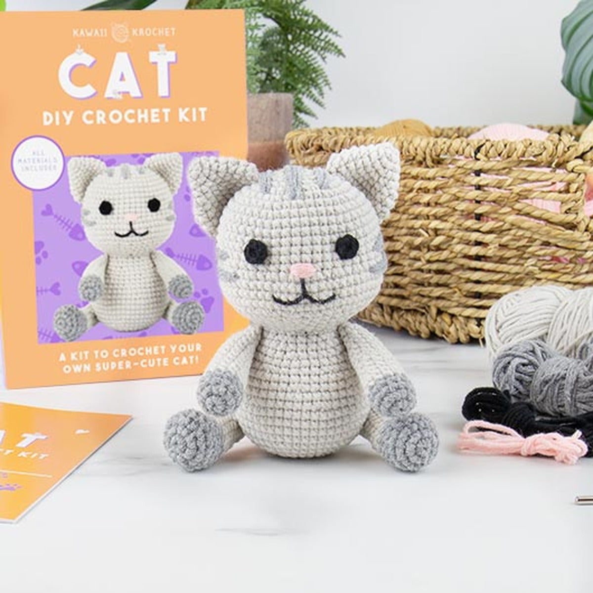 DIY cat crochet kit with the finished grey cat and yarn