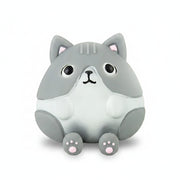 Grey cat stress toy at rest on a bright blue background