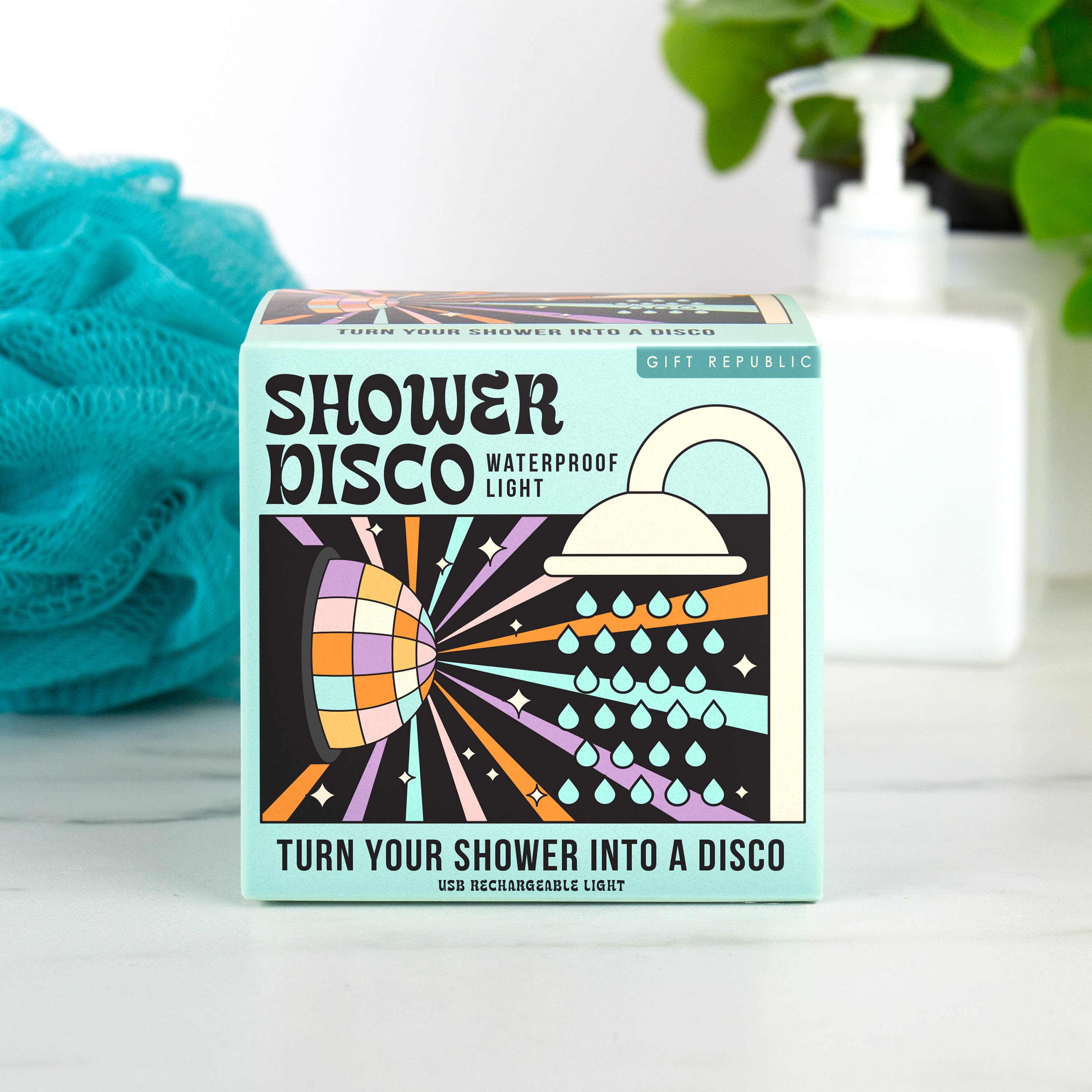 Shower Disco light box displayed in a bathroom beside a blue shower puff