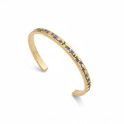 Gold bracelet with floral design on a white background