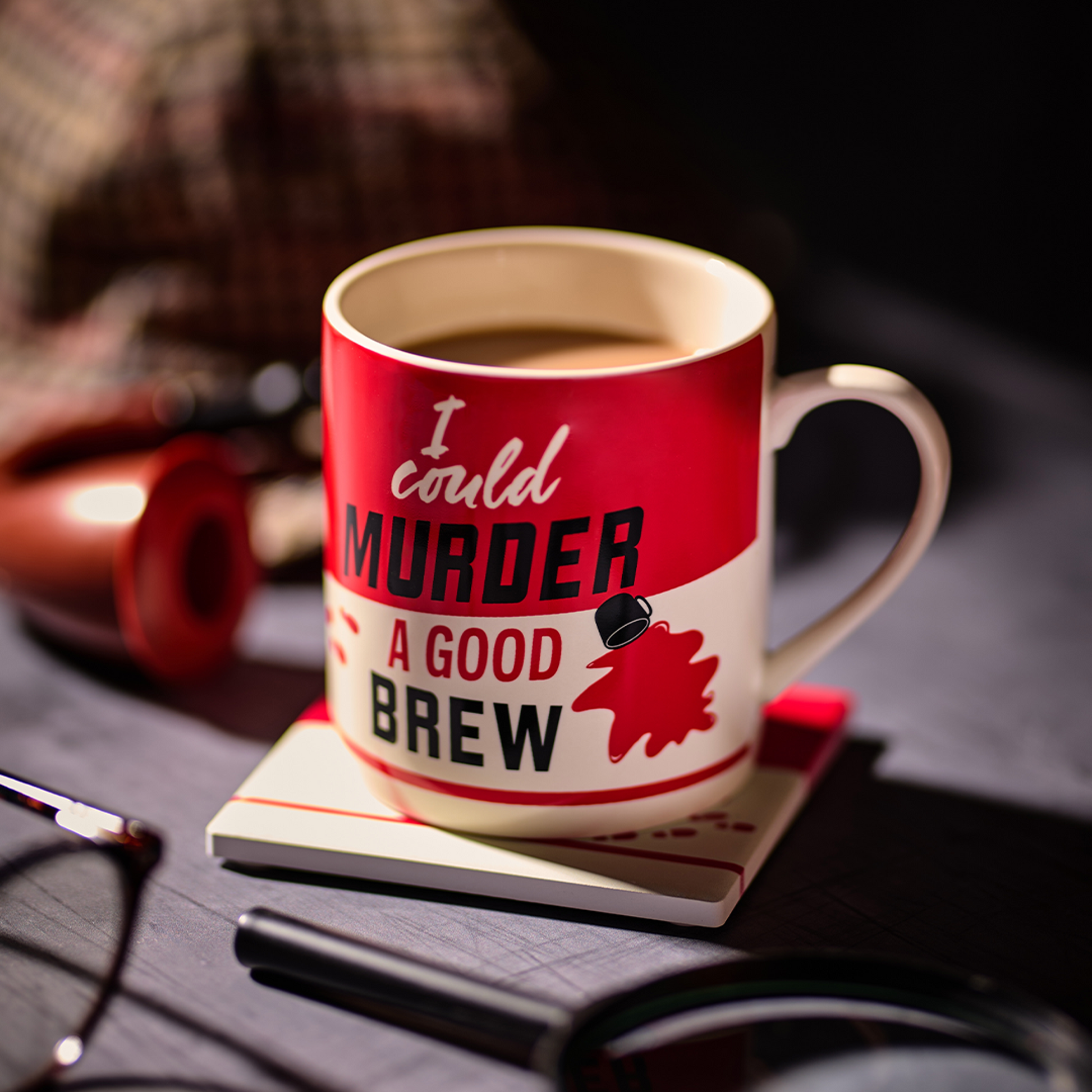 Brew mug styled on a desk with reading glasses and headphones