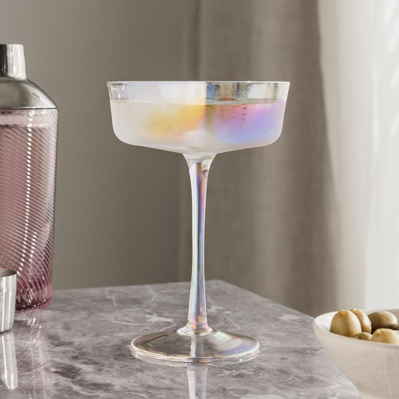 Heart-shaped iridescent coupes in a styled setting