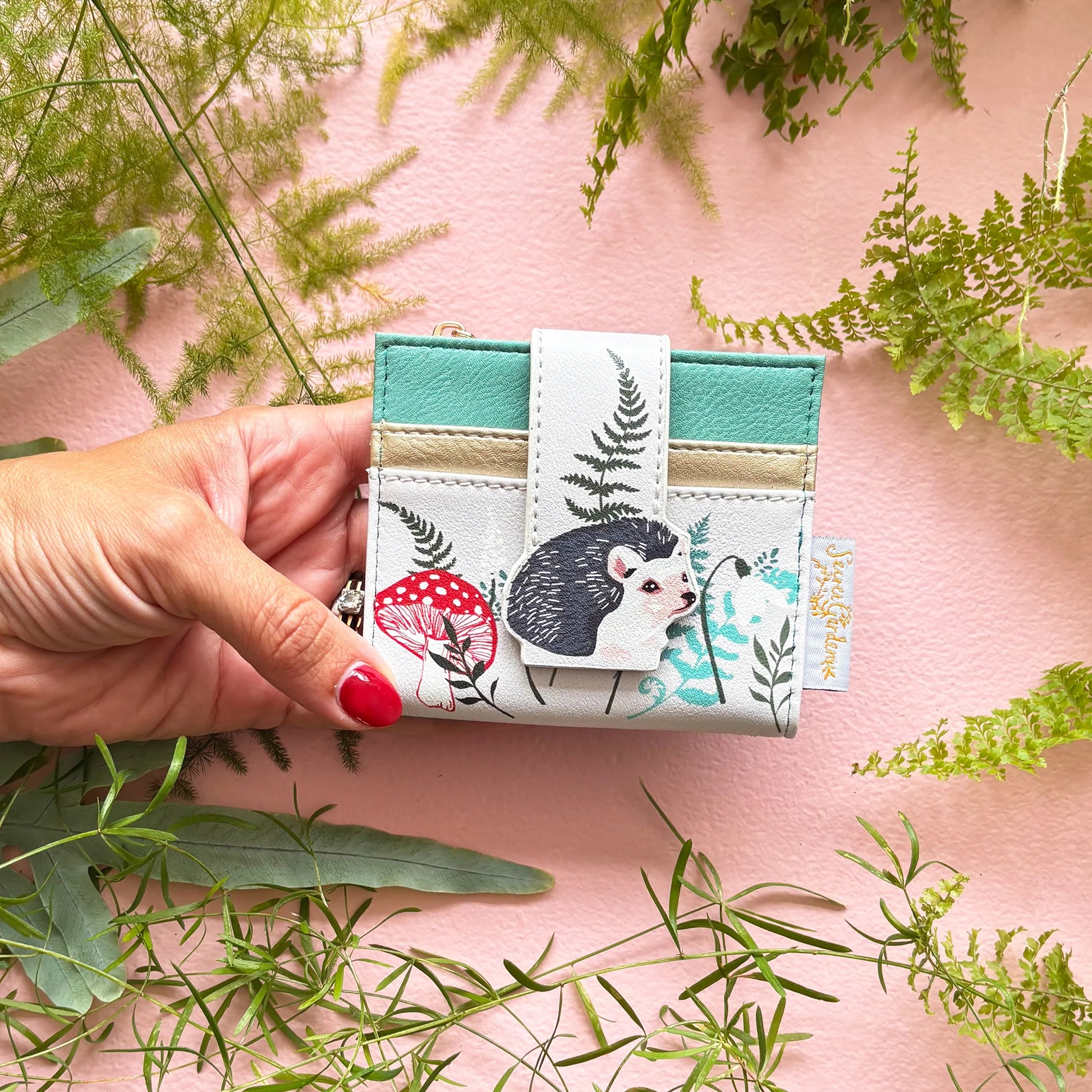 Hedgehog purse held in hand showing compact size