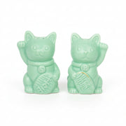 Two green ceramic lucky cat salt and pepper shakers, white background