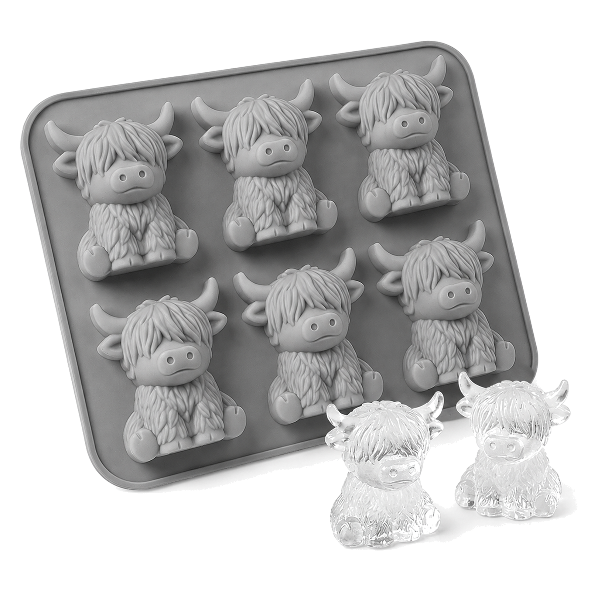 Grey silicone mould with six Highland cow cavities beside two clear cow-shaped ice cubes