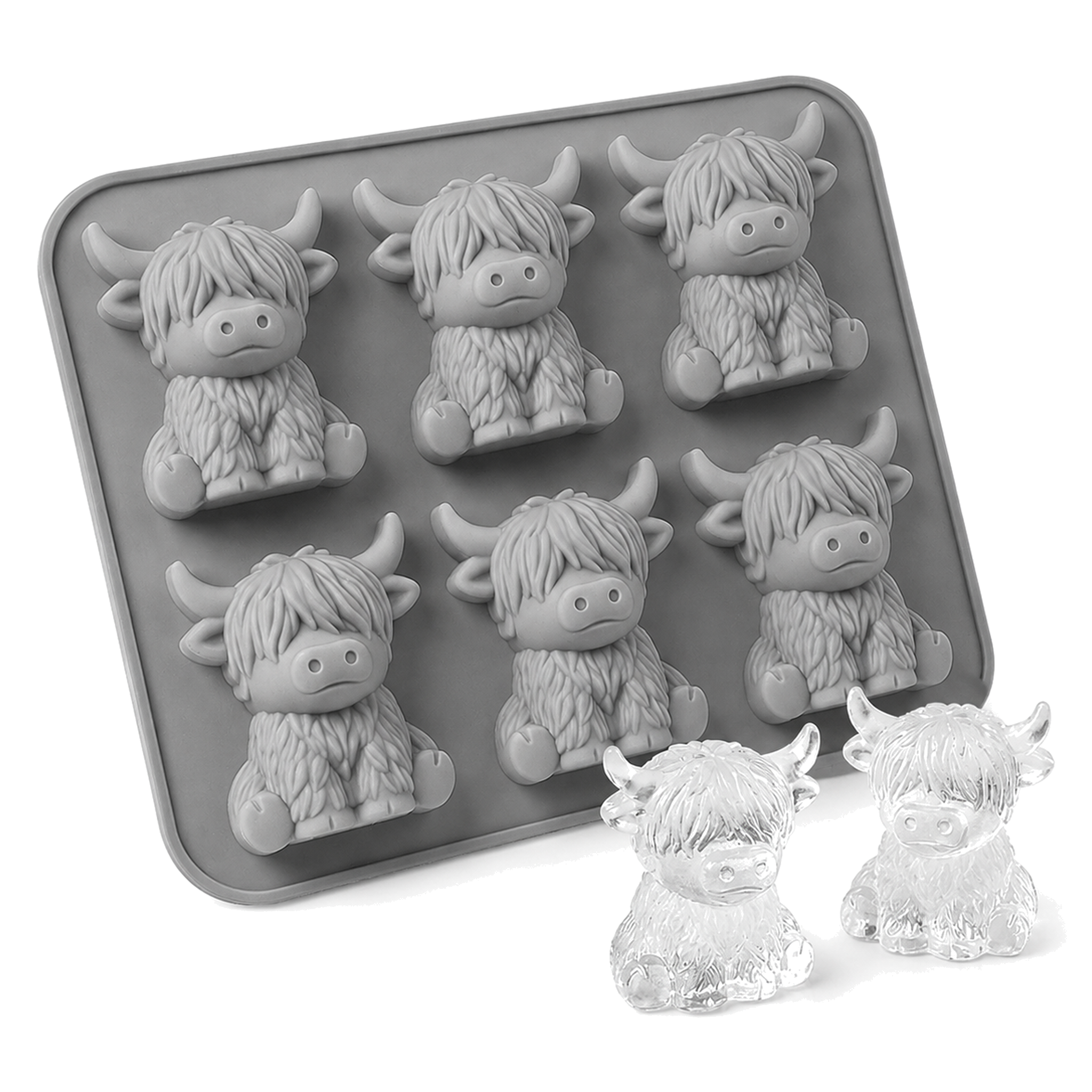 Grey silicone mould with six Highland cow cavities beside two clear cow-shaped ice cubes