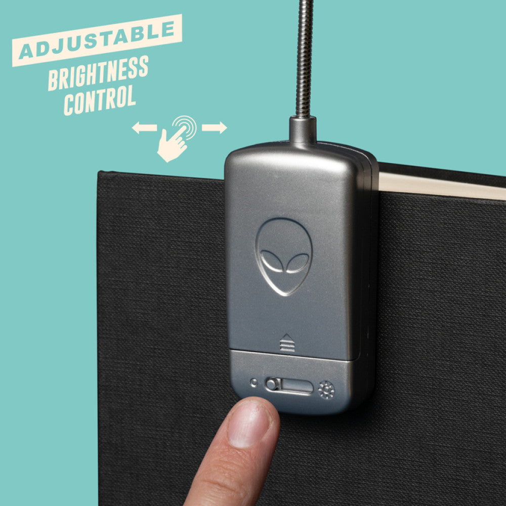 Thumb pressing the adjustable brightness switch on the battery pack