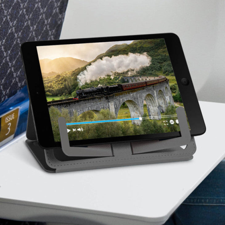 Grey Travel Book Rest propping up a tablet on an aeroplane tray table