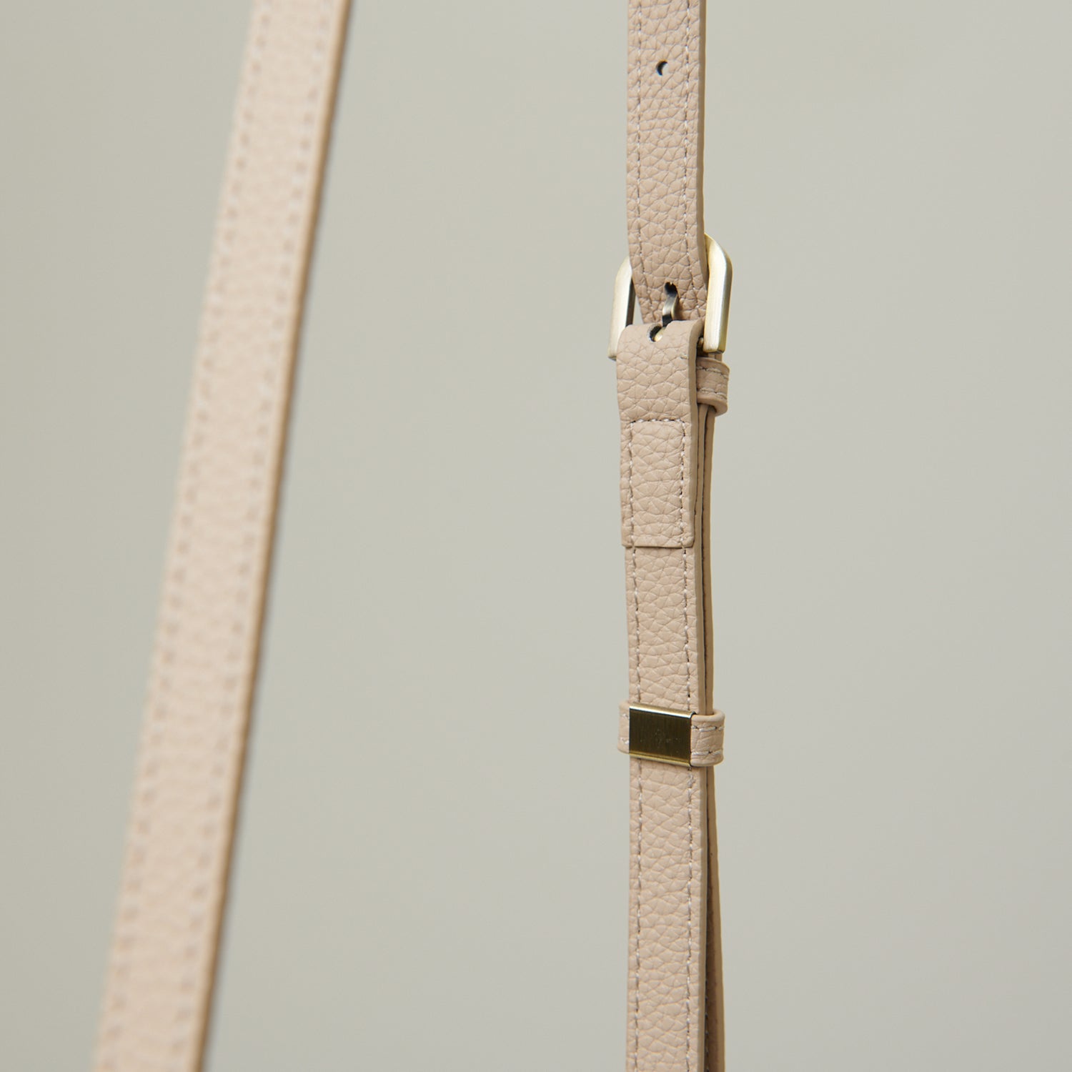 Close-up of Islander clasp and Harris Tweed label on blue teal tartan