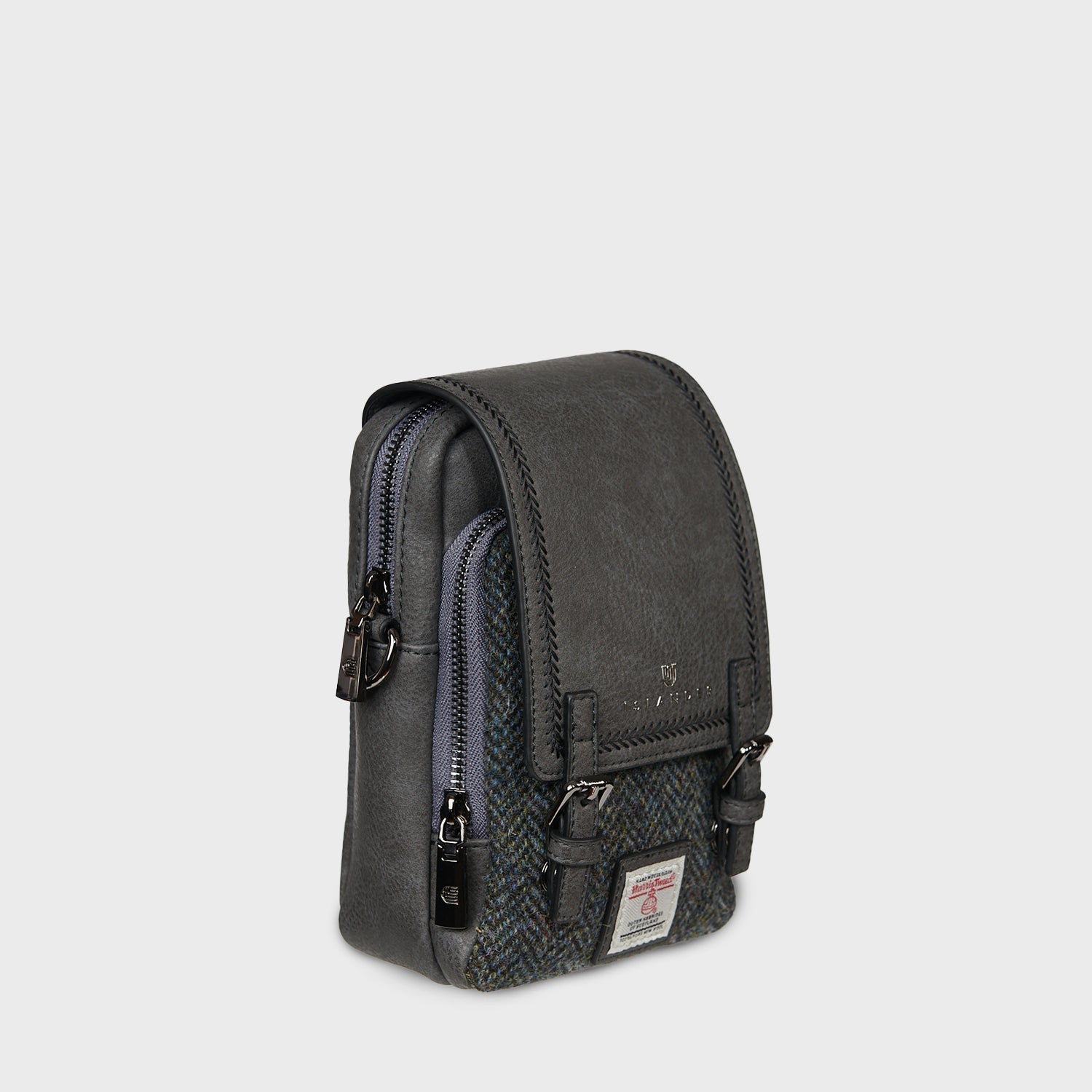 Side of the black Baby Jura crossbody showing the zip and strap clip