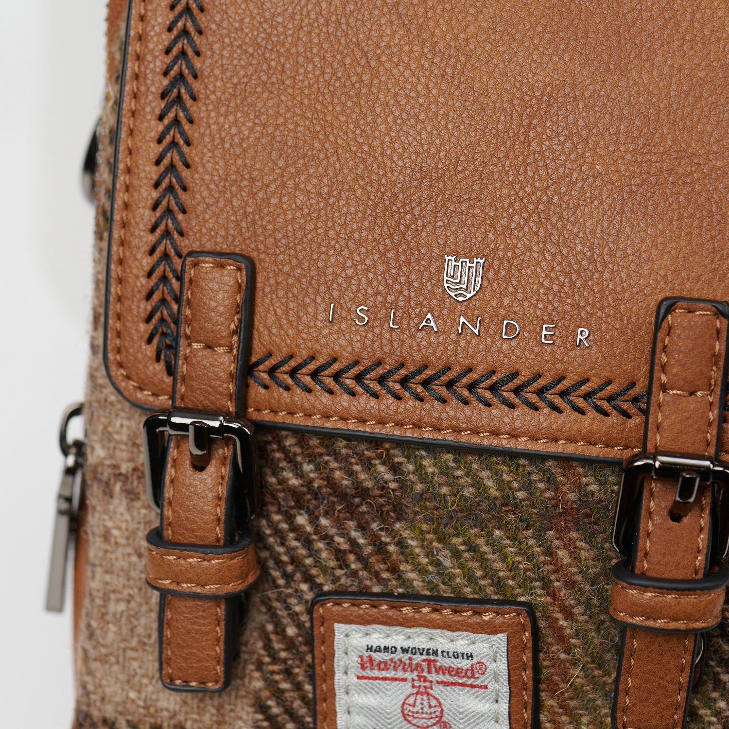 Close up of the chestnut tartan tweed and the Harris Tweed orb label