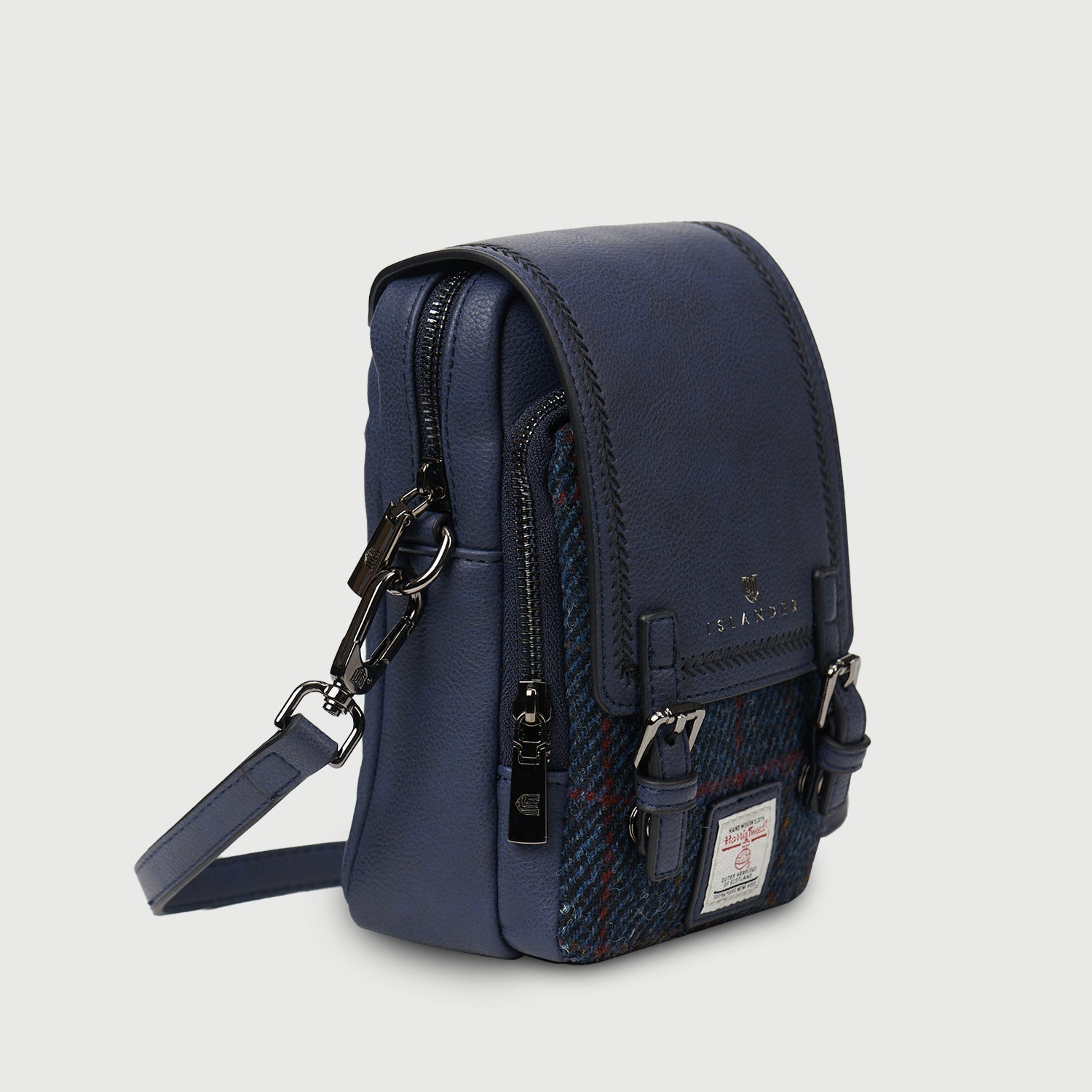 Navy crossbody bag side view showing top zip, side zip and strap clip
