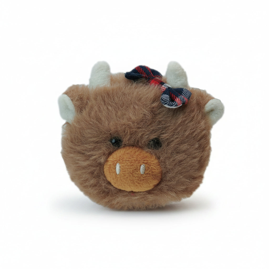 Daisie Highland cow magnet front view with tartan hair bow on white background