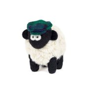 Knitted Erin sheep wearing a blue and green tartan flatcap