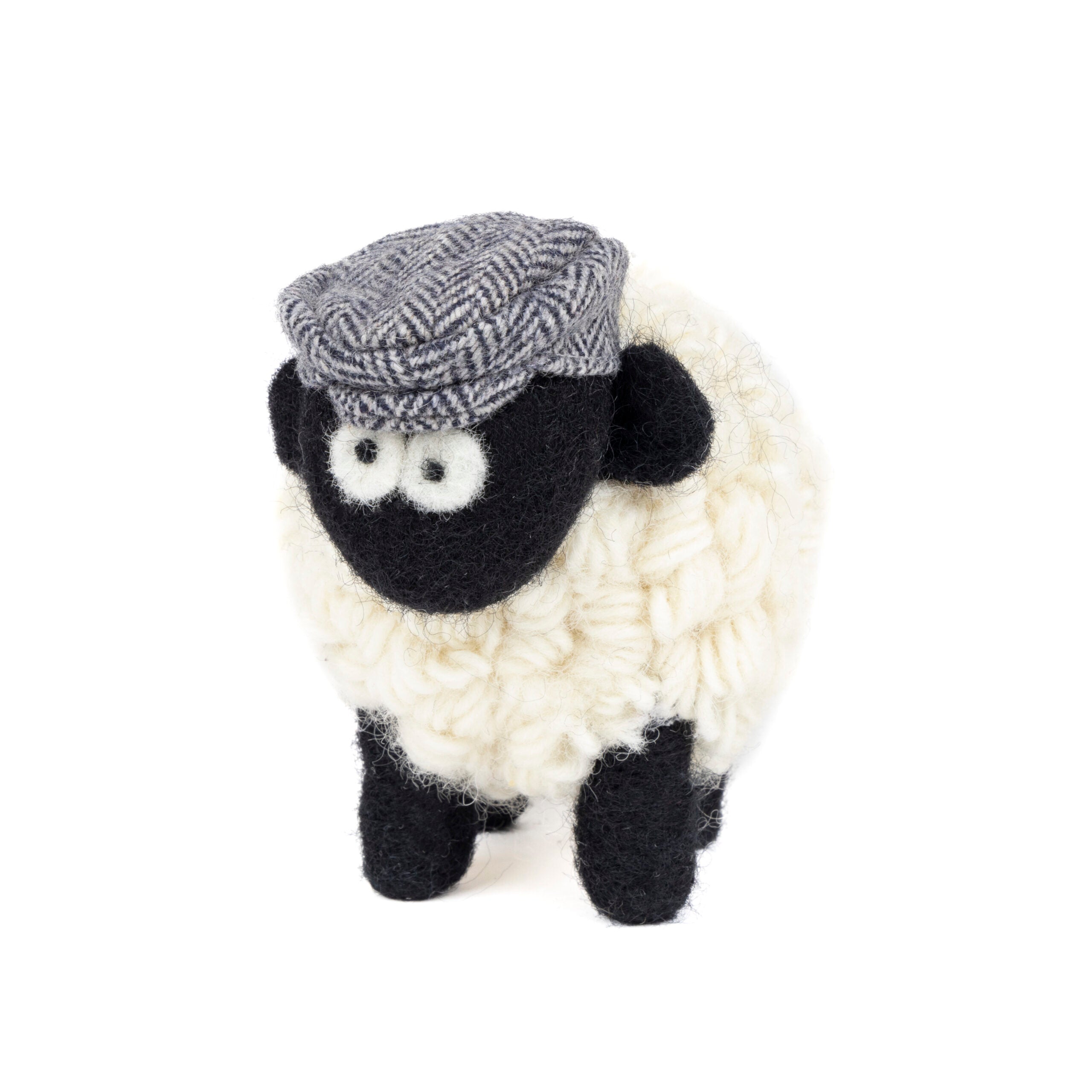 Knitted Erin sheep wearing a blue herringbone tweed flatcap