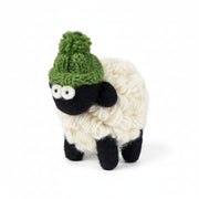 Hand-knitted wool sheep figure wearing a green bobble hat