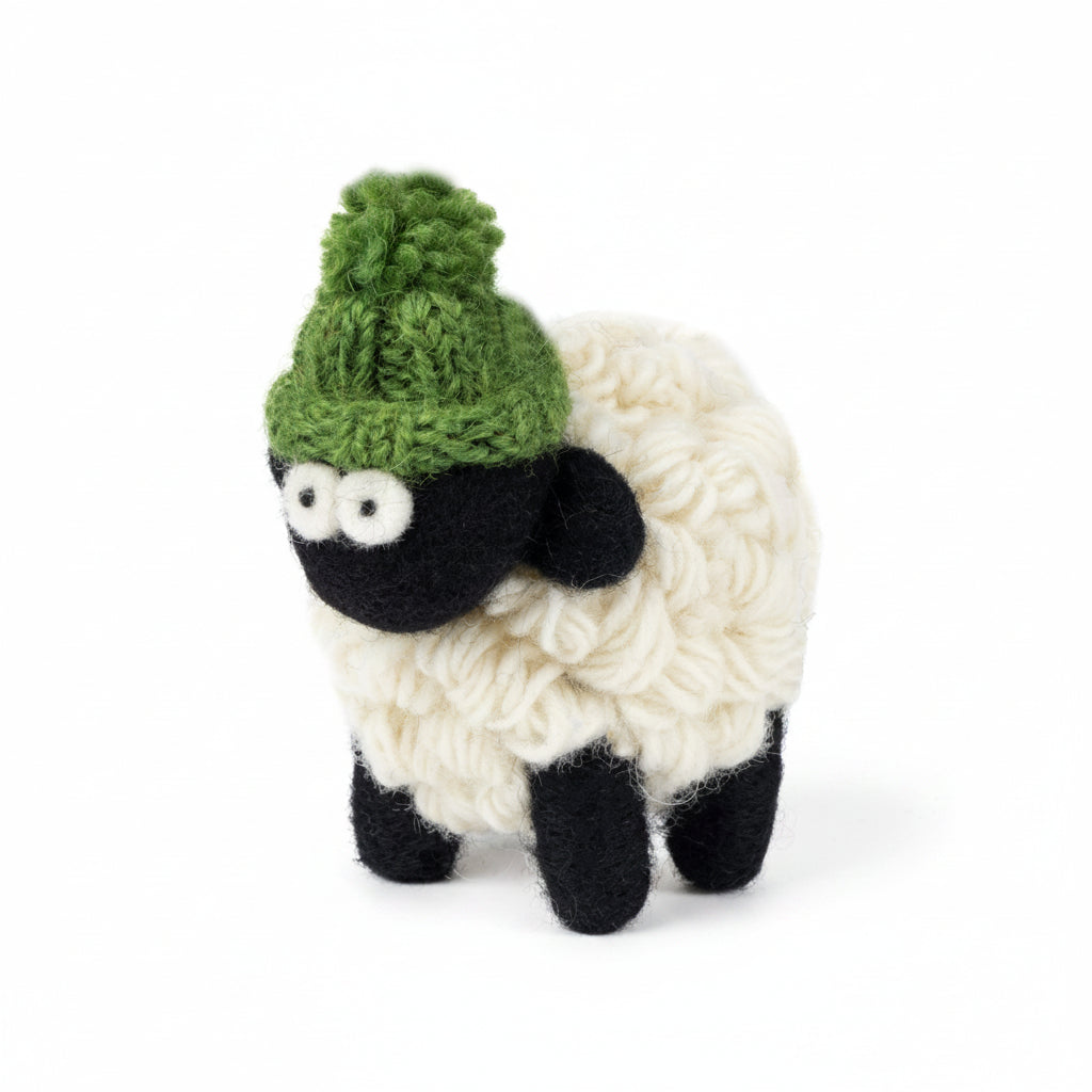 Hand-knitted wool sheep figure wearing a green bobble hat