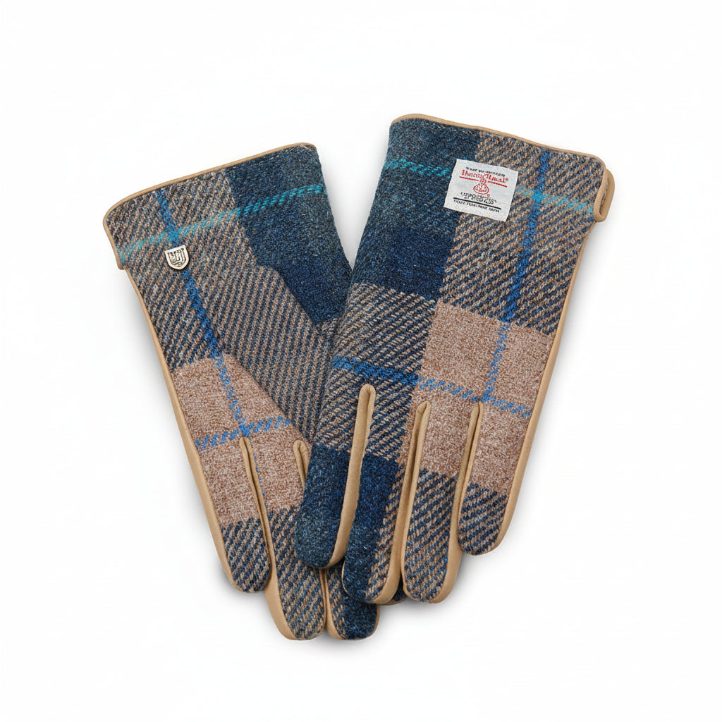 Navy beige tartan Harris Tweed gloves holding steaming mug on wooden fence outdoors